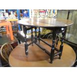 An antique two flap gateleg table having one drawer and a set of 4 ladderback chairs