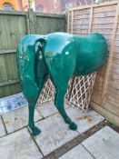 A modern plastic life size rear half of a horse