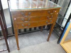 An old canteen of silver plated cutlery with 3 long drawers on square tapered legs
