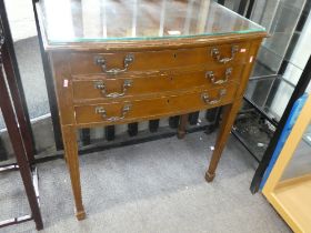 An old canteen of silver plated cutlery with 3 long drawers on square tapered legs