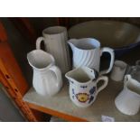 A selection of vintage china jugs and a mixing bowl and a chair