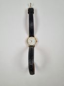 9ct yellow gold cased Tissot watch, Roman numerals, white dial, on black leather strap, watch marked
