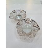 A pair of decorative silver bon bon dishes, having pierced hexagonal body, on a raised pedestal, cir