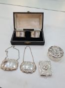 A cased pair of silver napkin rings by Turner and Simpson, with two silver decanter labels. Also wit