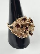 Zeeta; a 9ct gold dress ring of domed bouquet form set with 6 round cut garnets, marked 9ct Zeeta, 6