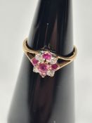 9ct yellow gold cluster ring with rubies and diamonds in a flower head, marked 375, size J, approx 1