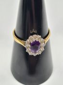 18ct and Platinum amethyst and diamond cluster ring central oval cut amethyst surrounded diamond chi
