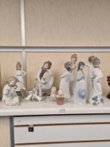 A quantity of Nao figurines, mainly children in night dresses
