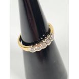 18ct yellow gold band ring with 5 rubover set round cut diamonds,, marked 750, maker PA, approx 3g