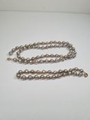 14ct gold clasped grey pearl necklace, each pearl separated by a 14ct gold ball, and a matching brac