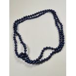 Modern strand of blue coloured pearls, knotted, various shapes