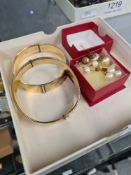 Two pairs 9ct gold studs each set with a pearl and two rolled gold bangles