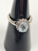 9ct white gold dress ring with oval aquamarine surrounded clear stones, marked 375, size K, approx 2