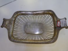 A decorative pierced design fruit bowl, by Walker and Hall, having reeded border and two scroll hand