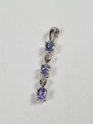 9K white gold pendant set tanzanite and diamonds, 3cm marked 375, maker TJC, with Certificate of Aut