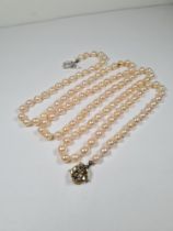 Single strand of pearls, 94cm, with 14ct white gold clasp set with blue paste, marked 585