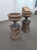A pair of late 19th Century Doulton Lambeth stoneware urns on square pedestal bases, 92cm