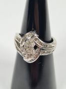 9ct white gold diamond dress ring of contemporary design, set with mixture of round brilliant and ba