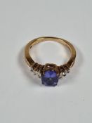 9ct yellow gold dress ring with central oval cut Tanzanite flanked each side with two baguette and o