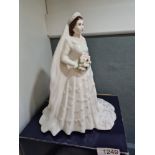 A Royal Worcester figure of the Late H.M. Queen Elizabeth II, in wedding dress, and one other of the