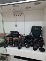 A modern Canon EOS 1300D camera, a EOS 1200D model, A Metz 45 cl-4 professional flash and a quantity