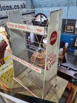 A vintage Coca Cola display stand in painted metal and one other bottle holder