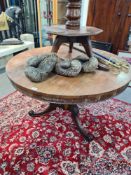 A Victorian rosewood circular dining table on turned pillar and tripod base, 115cm