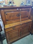 A late Victorian carved Walnut cabinet having fitted desk top with drawers and cupboards below, 111c