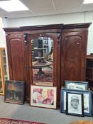A Victorian mahogany 3 section wardrobe, the central section having mirrored door with fitted interi