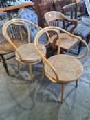 A pair of bentwood Dinette open arm chairs having cane seats