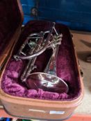 An old Besson & Co trumpet having floral decoration and a Boosey & Hawkes example, both cased
