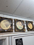A set of three circular prints of babies in decorative frames