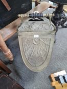 A Victorian brass coal scuttle of shell shape with embossed decoration