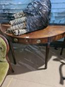 An antique mahogany consul table having central drawer and a Belgian rug