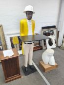 A carved wooden standing figure of servant in yellow jacket with white hat, 167cm