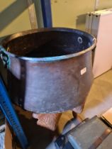 A large copper two handled cauldron and an iron footman