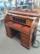 An antique twin pedestal desk having 6 drawers with cylinder top 122cm