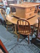 A set of 6 Ercol stickback kitchen chairs and an Ercol Elm 2 flap dining table, 141cm