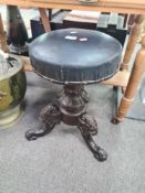 A Victorian revolving piano stool having carved decoration