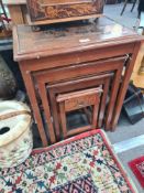 A nest of 4 oriental carved coffee tables, a poker World style small cabinet and a lacquer box