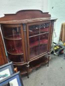 An Edwardian inlaid mahogany display cabinet having central door with undertier