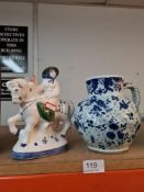 An old Delft Jug decorated birds and flowers and a Rye pottery figure on horseback