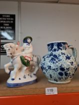 An old Delft Jug decorated birds and flowers and a Rye pottery figure on horseback