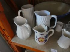 A selection of vintage china jugs and a mixing bowl and a chair