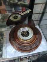 An early 20th Century, German carved barometer and one other