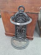 A Victorian style cast iron stick stand having pierced scroll back