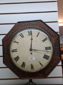A Victorian octagonal wall clock having brass inlaid decoration with painted dial, 30.5cm and pendul
