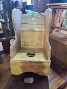 An old pine child's rocking chair - the seat having central hole