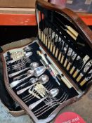 A large carton of mixed metalware and a canteen of cutlery