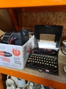 A vintage cased Remington typewriter and a box of cameras, binoculars, etc